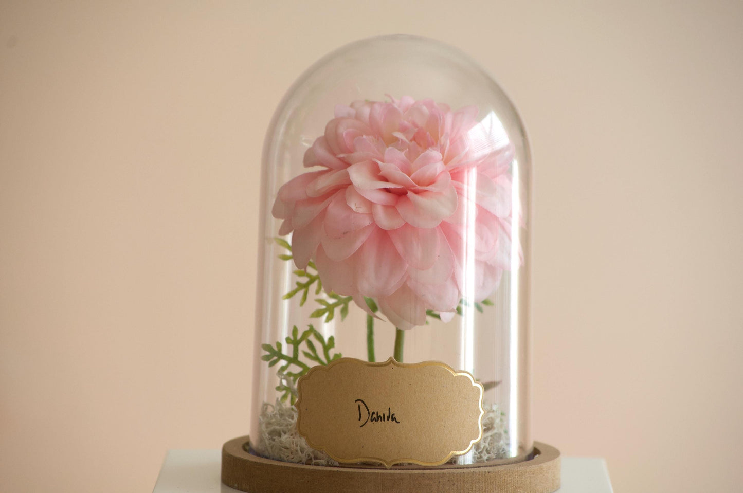 Dahlia silk flower arrangement inside of a flower cloche