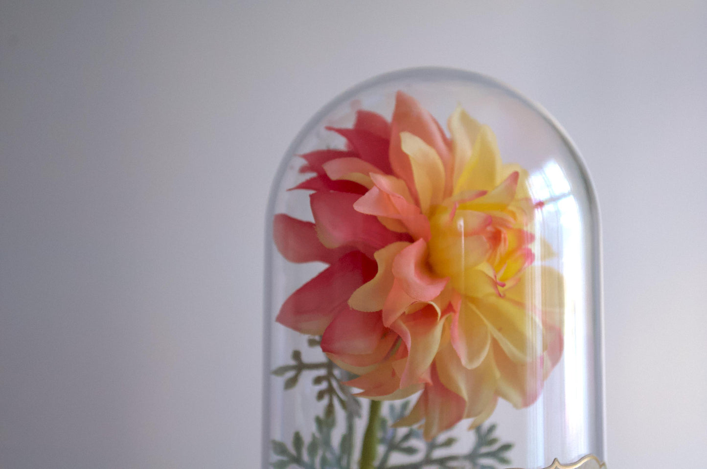 Dahlia silk flower arrangement inside of a flower cloche