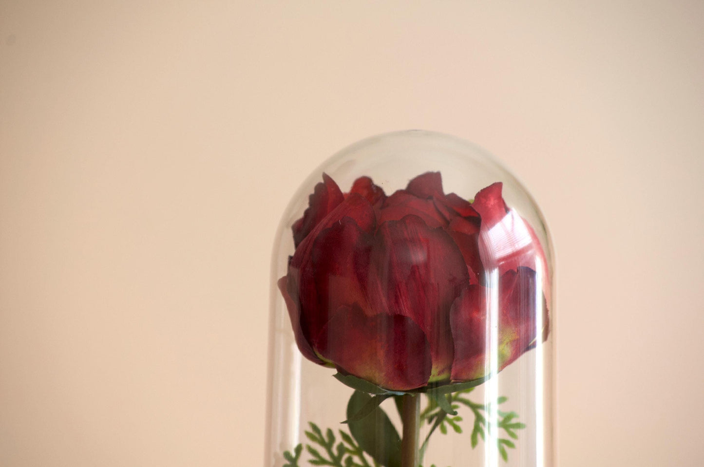 Peony silk flower arrangement inside of a flower cloche