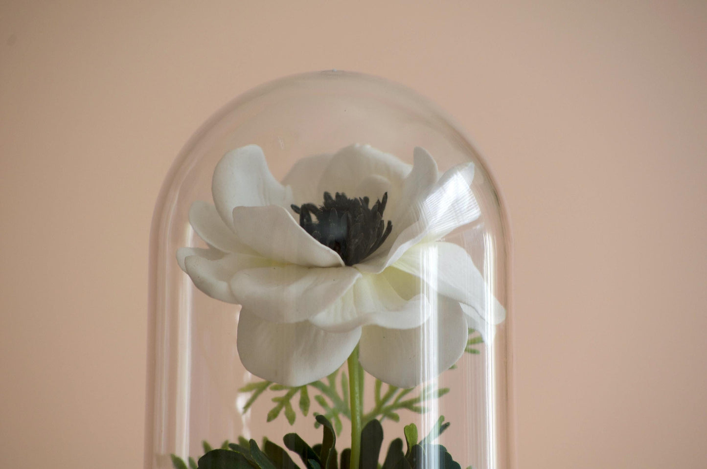 Anemone silk flower arrangement inside of a flower cloche