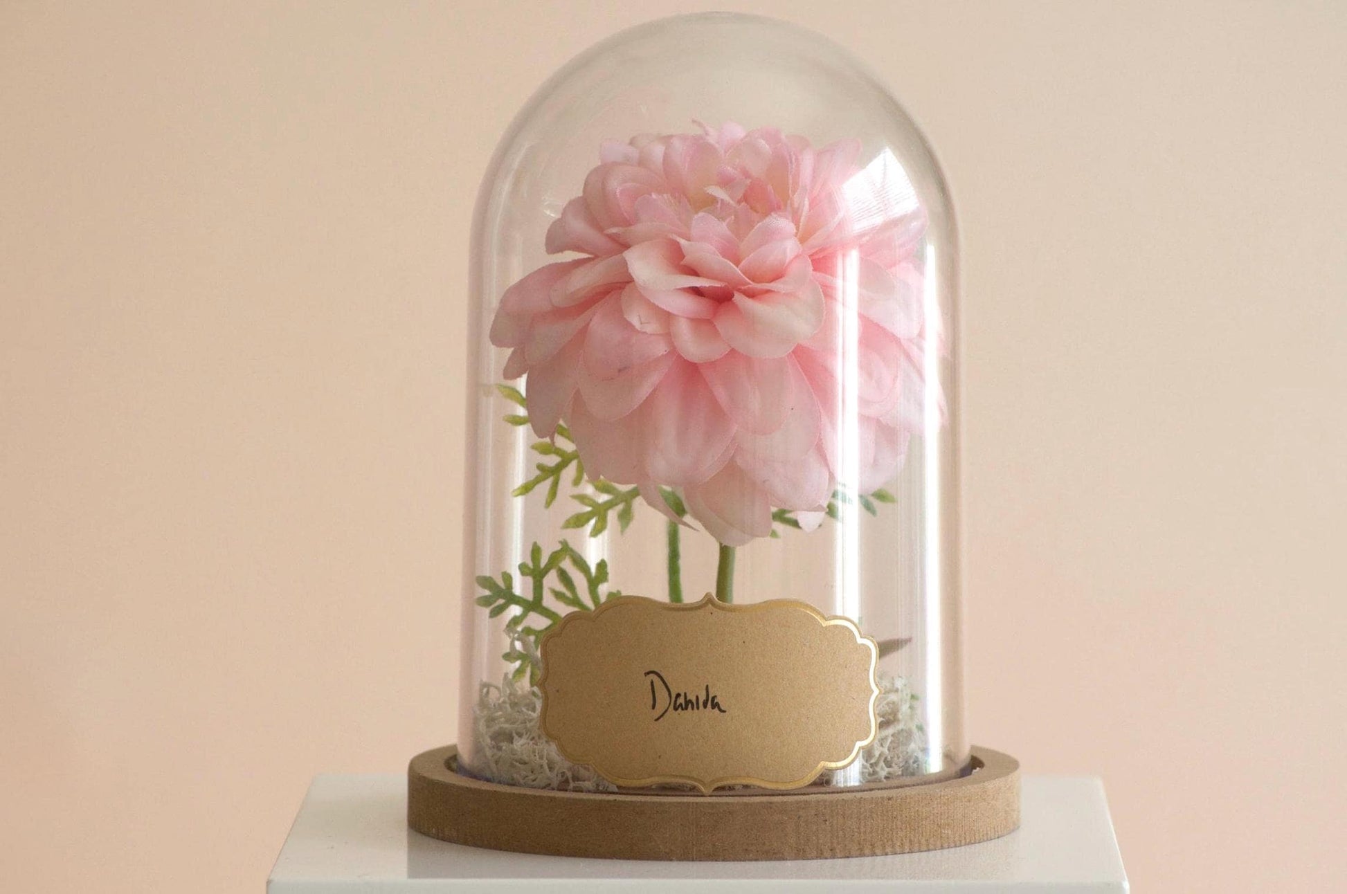 Dahlia silk flower arrangement inside of a flower cloche
