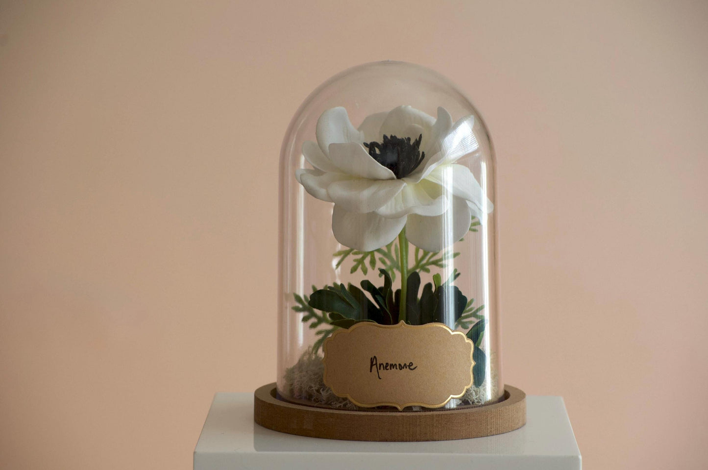 Anemone silk flower arrangement inside of a flower cloche