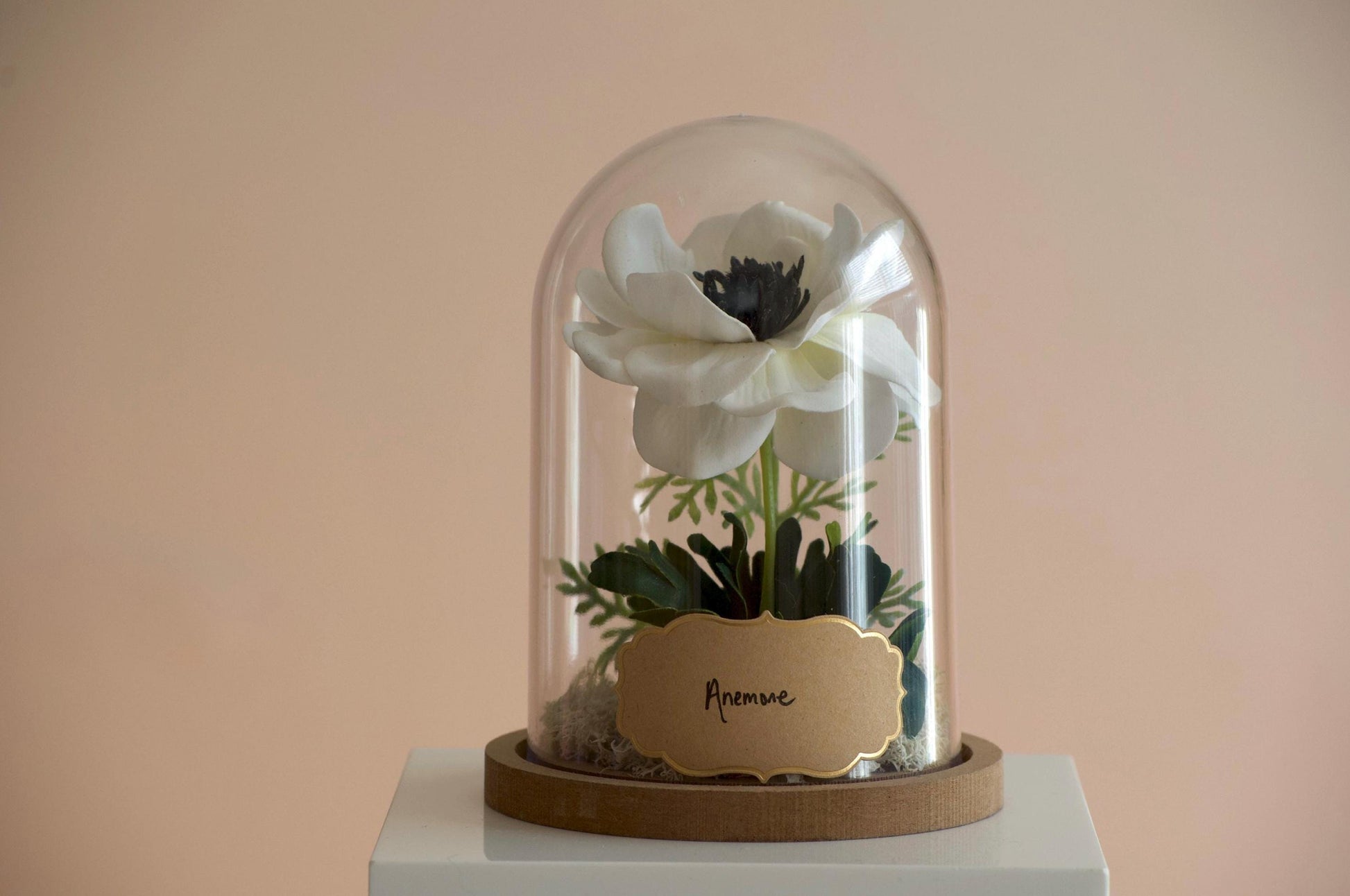 Anemone silk flower arrangement inside of a flower cloche