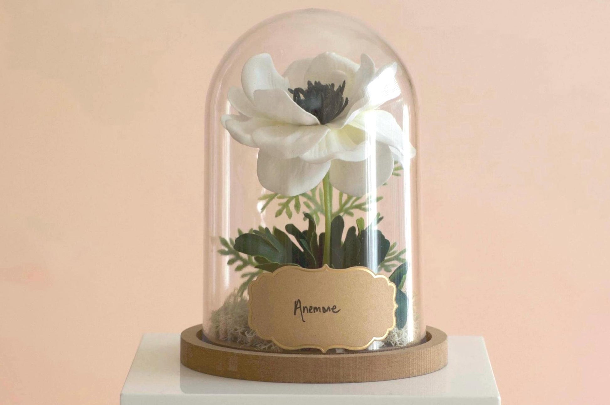 Anemone silk flower arrangement inside of a flower cloche